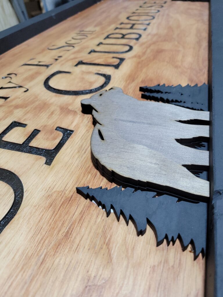 Layered elements on a custom wooden sign